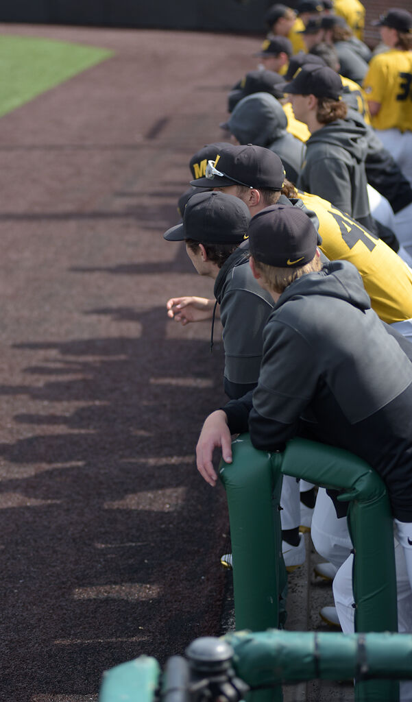 Mizzou baseball players hang out in the dugout on Saturday in Columbia.